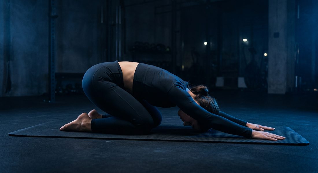 Athlete resting in child's pose